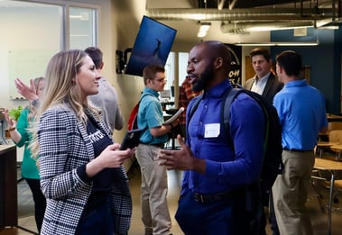 two recruiters talking to each other at a conference