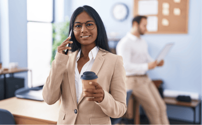 Professional smiling toward the camera while on the phone.