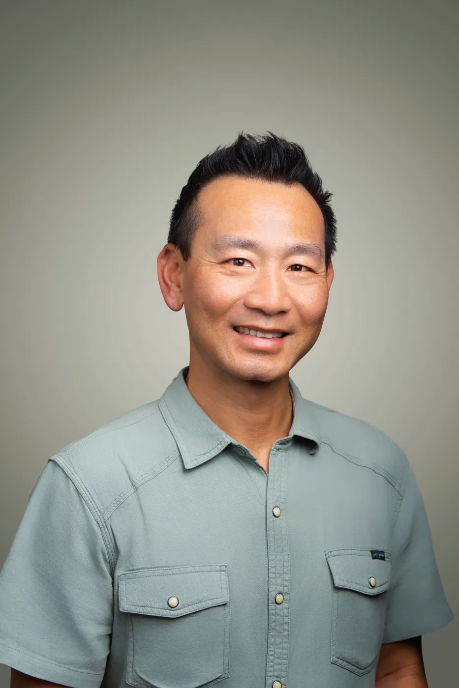 Headshot portrait of Kan Ta, Practice Lead, Eng & Tech