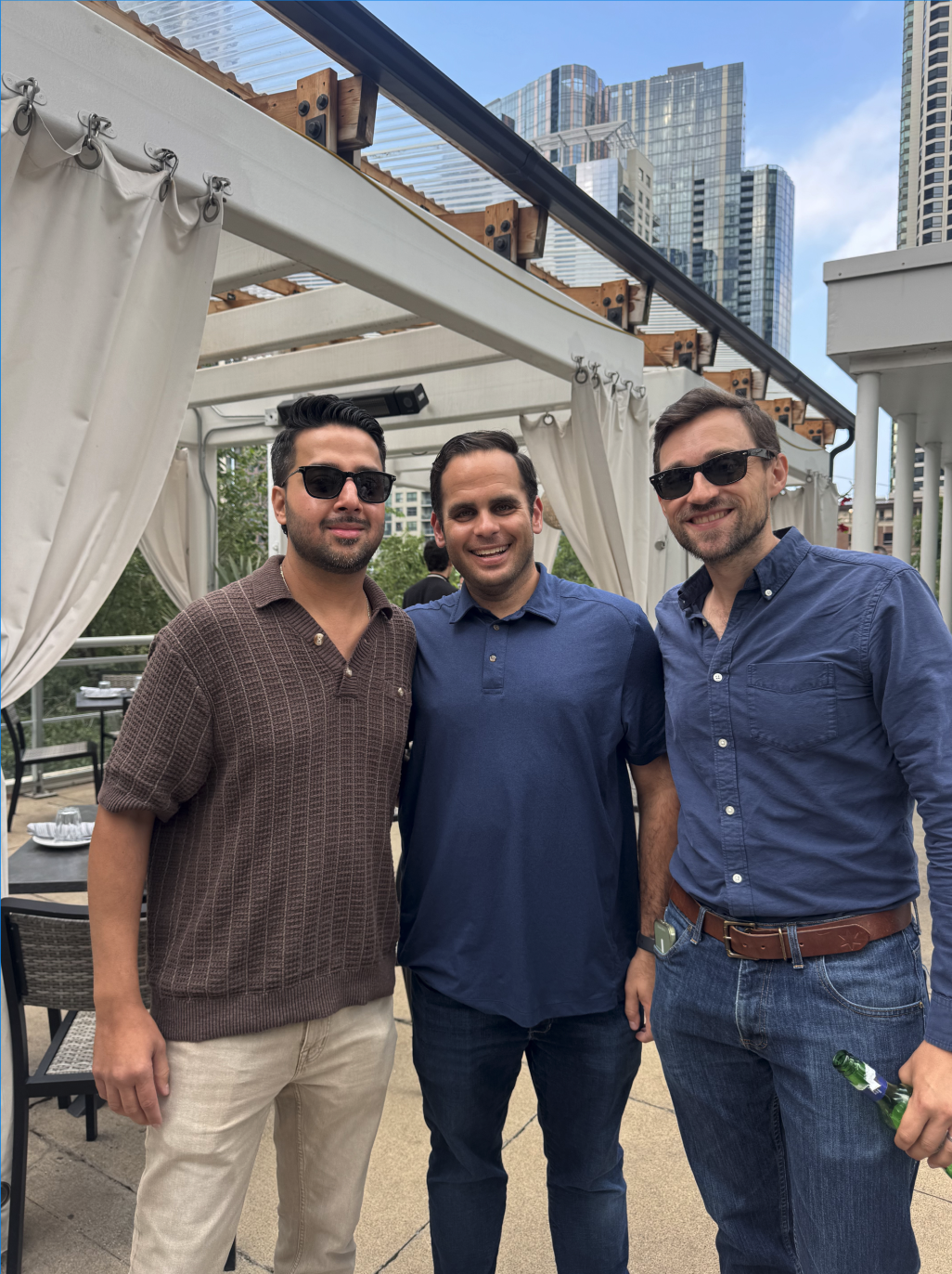 Hunt Club teammates smiling on a rooftop terrace