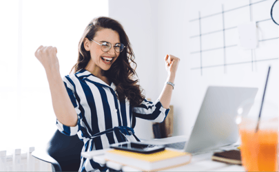 An excited client working at their laptop.