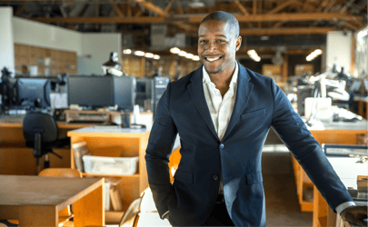 business man in suit standing in office and smiling