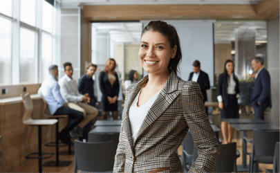 woman smiling in front of group of office workers behind her