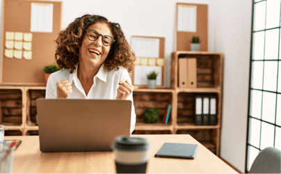 A very happy and content professional working at their laptop.