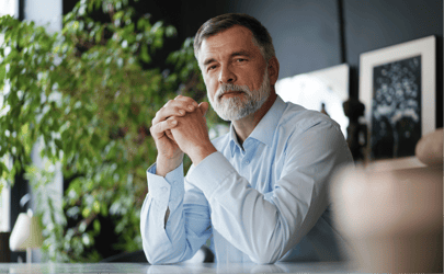 executive leader with hands folded on a desk