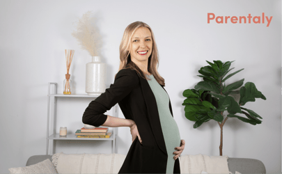 pregnant woman smiling and holding her belly