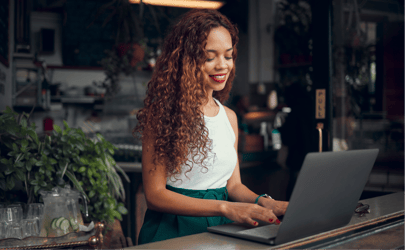 talent acquisition specialist on laptop in a cafe