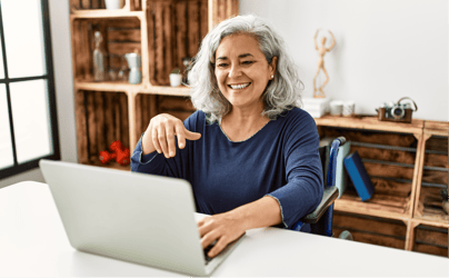 Woman smiling and working at computer.