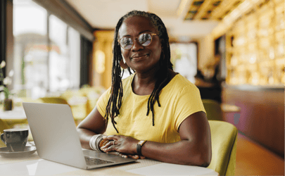 woman-in-yellow-shirt-near-laptop