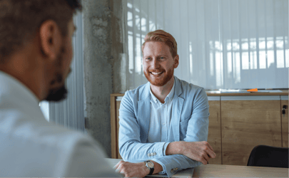 business man in foreground interviewing a candidate