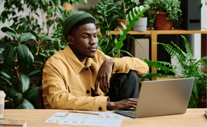 man sitting at desk working on an open laptop