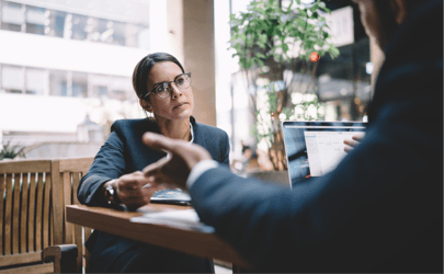 A professional sitting at a table responding to a colleague. 