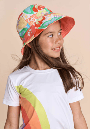 young girl modeling reima brands outdoor sun hat and t-shirt with a rainbow on it
