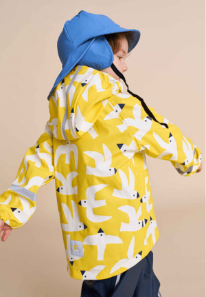 young boy modeling Reima brand yellow rain coat and blue hat