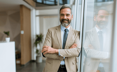 business man with crossed arms smiling