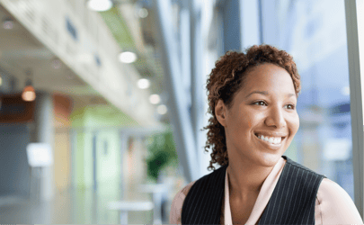 business woman smiling and looking out of window