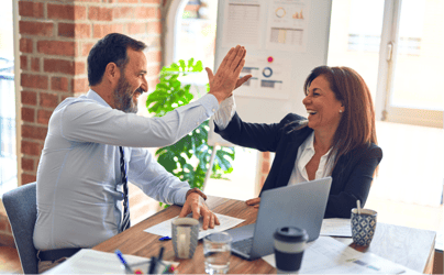 Two professionals exchanging a high five.