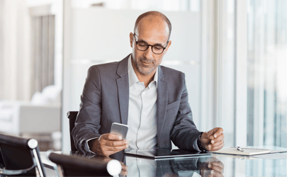 man with a phone looking at linkedin