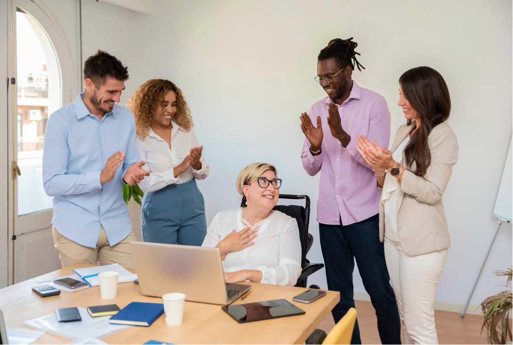 group applauding business woman