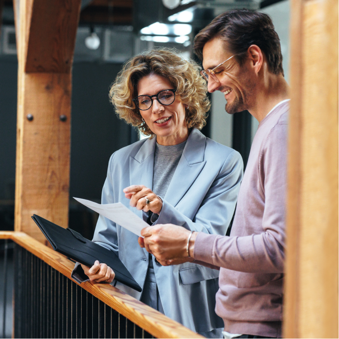 woman and man reviewing a paper document together