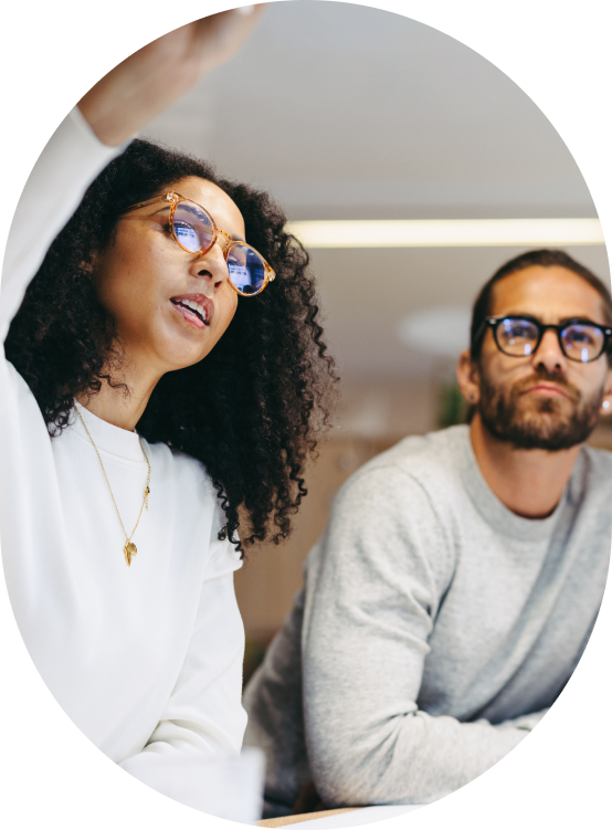 woman pointing at something out of frame while man looks at what she's pointing at 