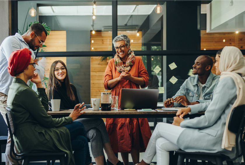 group of 6 colleagues meeting and smiling