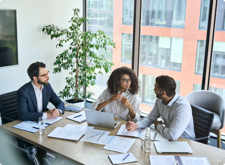 product team collaborating with papers on table in front of them