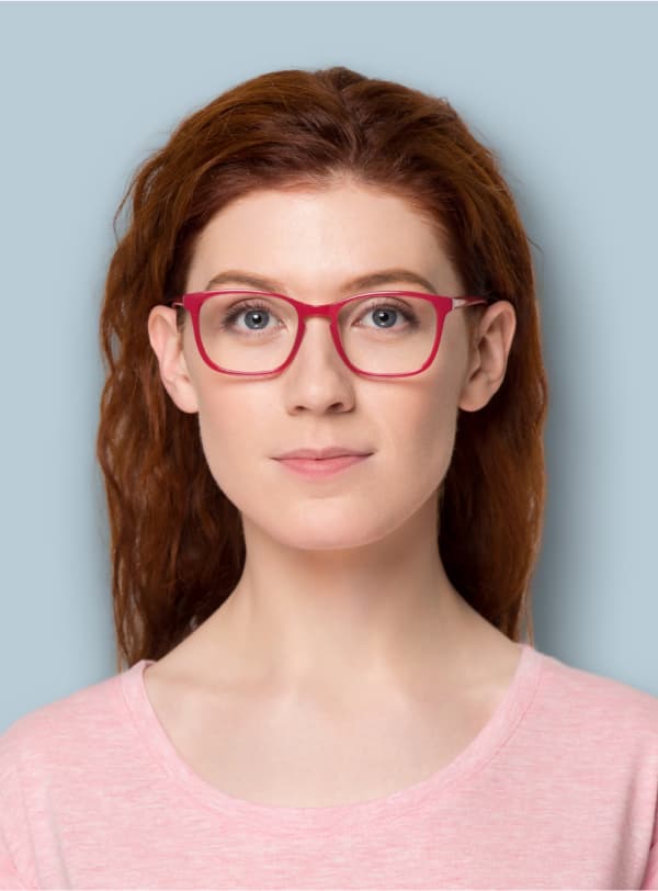 portrait of woman in red glasses grinning