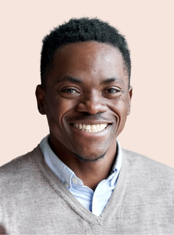 portrait of man in gray sweater smiling