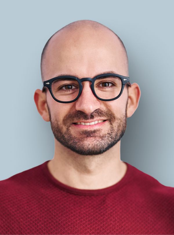 man with glasses in red shirt smiling