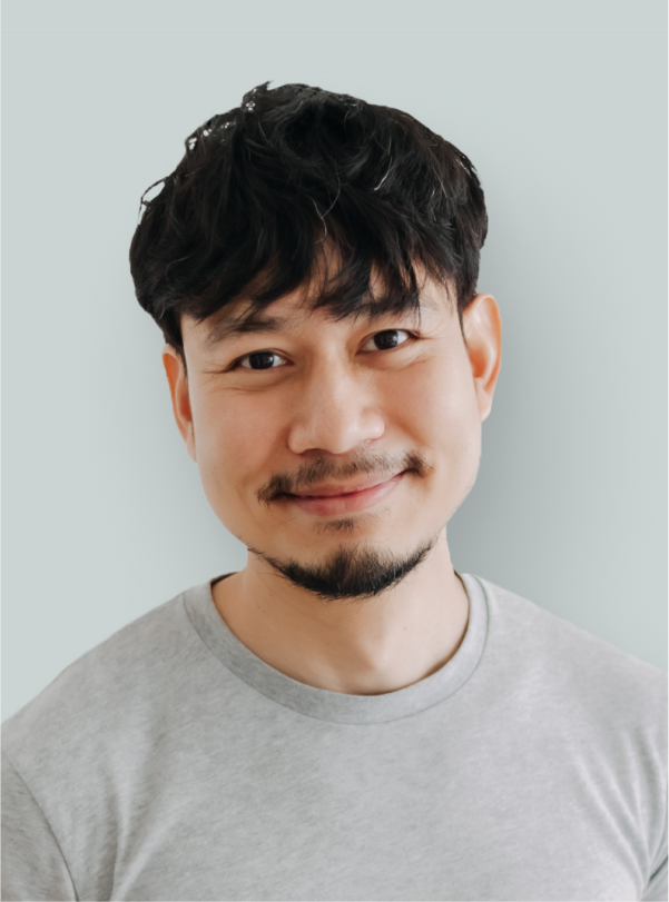 portrait of businessman in a gray shirt smiling at the camera