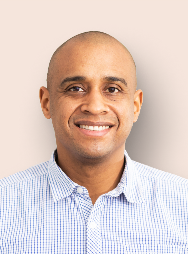 portrait of businessman in a blue collared shirtsmiling to the camera