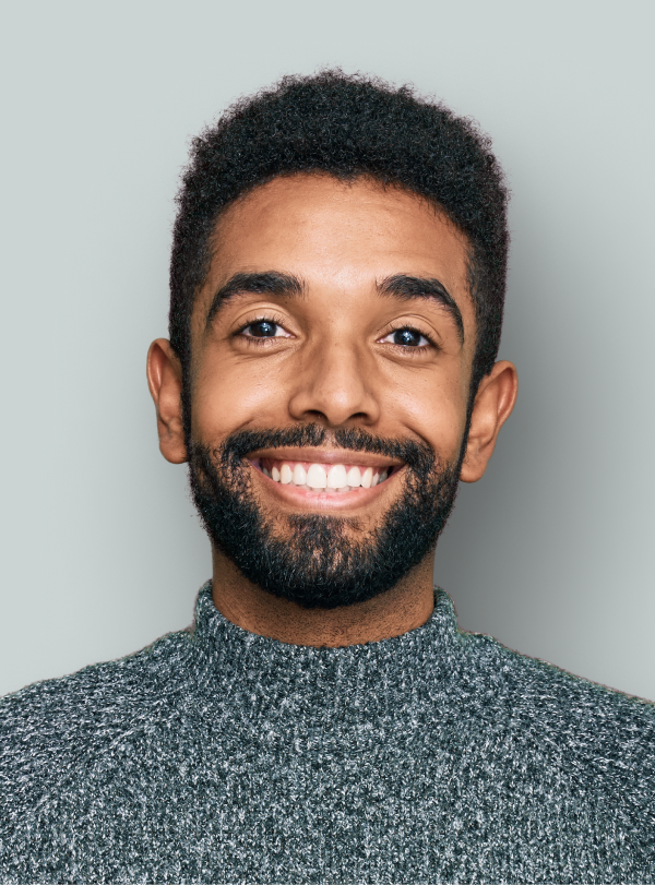 portrait of business man wearing a gray sweater smiling