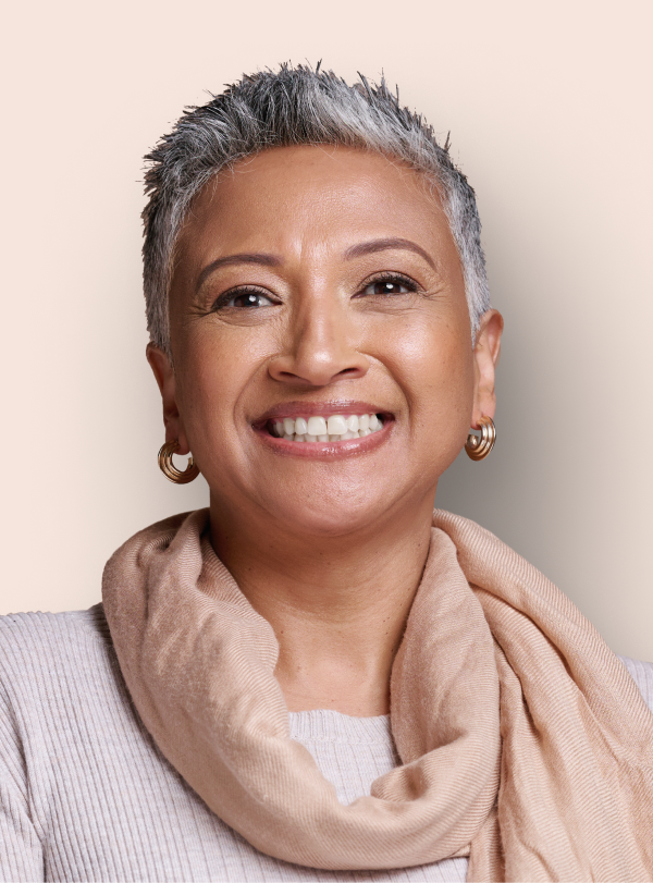 portrait of woman with earrings and scarf smiling