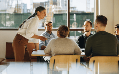 Group of professionals talking around a table.