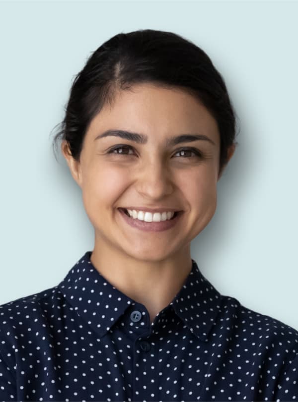 portrait of woman in polka dot blouse smiling